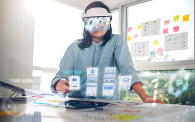 asian woman using augmented reality (ar) glasses simulation ux ui design for working on table at...