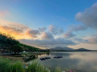 The atmosphere of the tent with a view of the surroundings and the mountains and there is a thin mist nearby and beautiful pine trees all around.