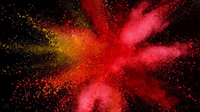 Super slow motion of coloured powder explosion isolated on black background.