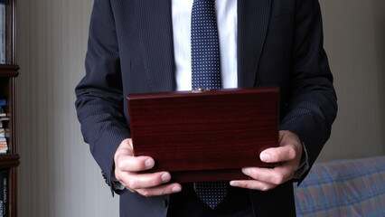 lacquered wooden box in hand