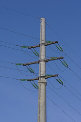 high power line pole on the background of the spring sky