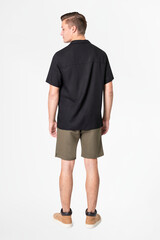 Fototapeta premium Man in black shirt and shorts with design space casual wear fashion rear view