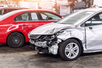 Fototapeta na wymiar Many wrecked car after traffic accident crash at restore service maintenance station garage indoor. Insurance salvage vehicle auction wholesale storage. Auto body wreck damage work workshop center