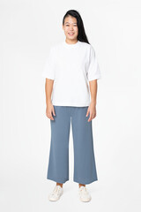 Woman in white tee and blue loose pants minimal fashion