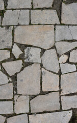 old cracked white tiles of stone and weathered broken floor - rough texture background