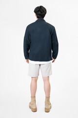 Man in navy jacket and shorts streetwear rear view