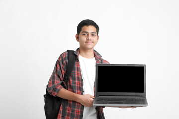 Indian college student showing laptop screen on white background.