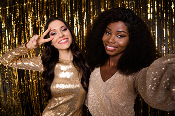 Photo of optimistic brunette ladies do selfie show v-sign wear nice dress isolated on bright gold color background
