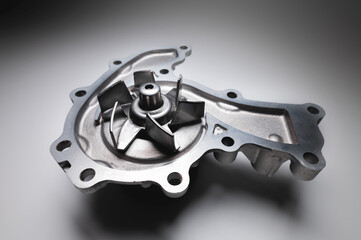Water pump of the internal combustion engine cooling system. Contrasting on a gray gradient