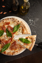 fresh italian pizza on black background