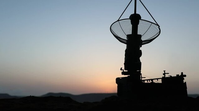 Space radar antenna on sunset. Silhouettes of satellite dishes or radio antennas against night sky. Creative artwork decoration. Selective focus