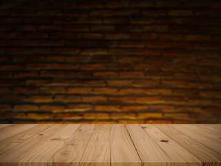 Empty perspective brown old plank wooden board as mock up display shelf with abstract beautiful blurred brown brick blocks wall in coffee shop and warming light from electric lamp background.