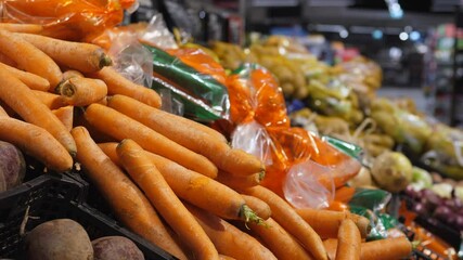 Shopping for food in big store. Grocery shop display of fresh prepacked and package free vegetables sold by weight