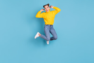 Fototapeta na wymiar Full size photo of cheerful carefree person jumping hands checking hair isolated on blue color background