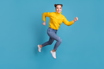 Fototapeta na wymiar Full body profile photo of cheerful excited girl jump running look camera isolated on blue color background