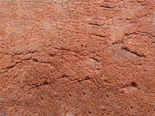 Textured wall with irregularities and roughness of red color .Texture or background