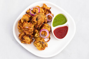 Crispy Indian Street Food With Various Names Like Onion Bhajji Pyaj Pakora Or Pakore Pyaaj Ke Pakode Or Pakoda Kanda Bhaji Pyaaz Bajji Served With Chutney And Sauce Is Tea Time Chaat Snacks