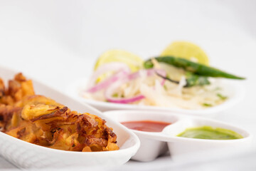 Indian Street Food With Various Names Like Onion Bhajji Pyaj Pakora Or Pakore Pyaaj Ke Pakode Or Pakoda Kanda Bhaji Pyaaz Bajji Served With Green Chutney And Ketchup Is Evening Tea Time Chaat Snacks