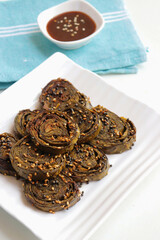 Alu Vadi, Patra, paatra, colocasia leaves roll, Patrode is a popular Indian healthy steamed snack. Garnished with sesame and mustard seeds. served with tamarind chutney. copy space.