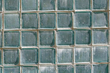 The wall is lined with numerous glass blocks