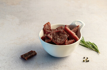tasty thin strips of selected beef. marinated, smoked, and dried meat jerky. high in protein snacks. copy space.