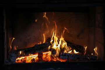 Close up of a burning fireplace at home - obrazy, fototapety, plakaty