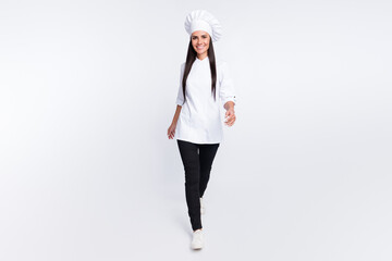 Full size photo of satisfied person walking toothy smile look camera wear cap isolated on white color background