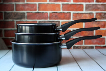 Ladles for cooking on a wooden table. Pot with handle