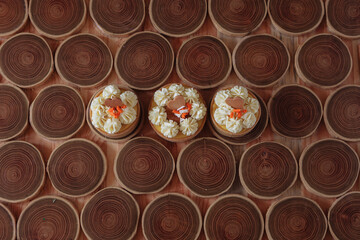 dessert, cheesecake with mango and passion fruit in the form of brownies with mousse on top. Decorated with cookies in the form of a heart. On a wooden table in a white plate
