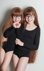 portrait of happy girls in a sports gymnastic swimsuit