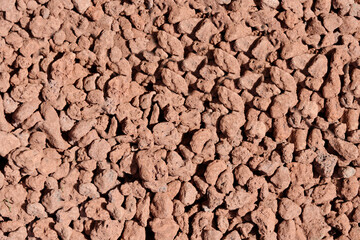 Expanded clay granules close-up of brown color.Texture or background