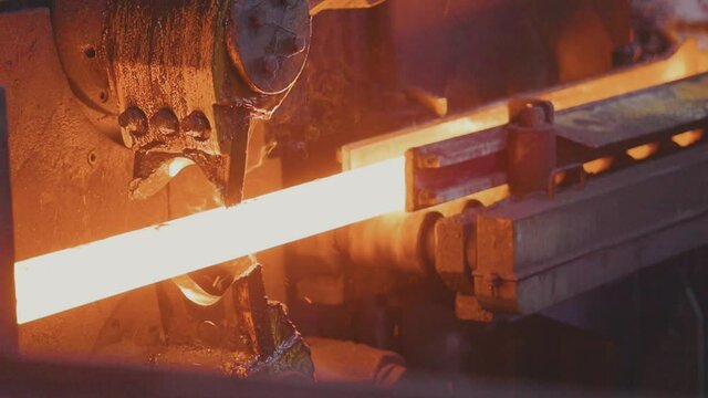 Red hot metal in a modern factory slow motion. Metal production process in a metallurgical factory. Modern metallurgical factory
