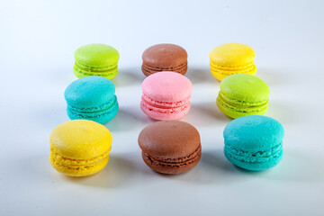 colored fresh macarons in studio on white background