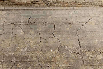 A close-up of a car's tire tread print on the road