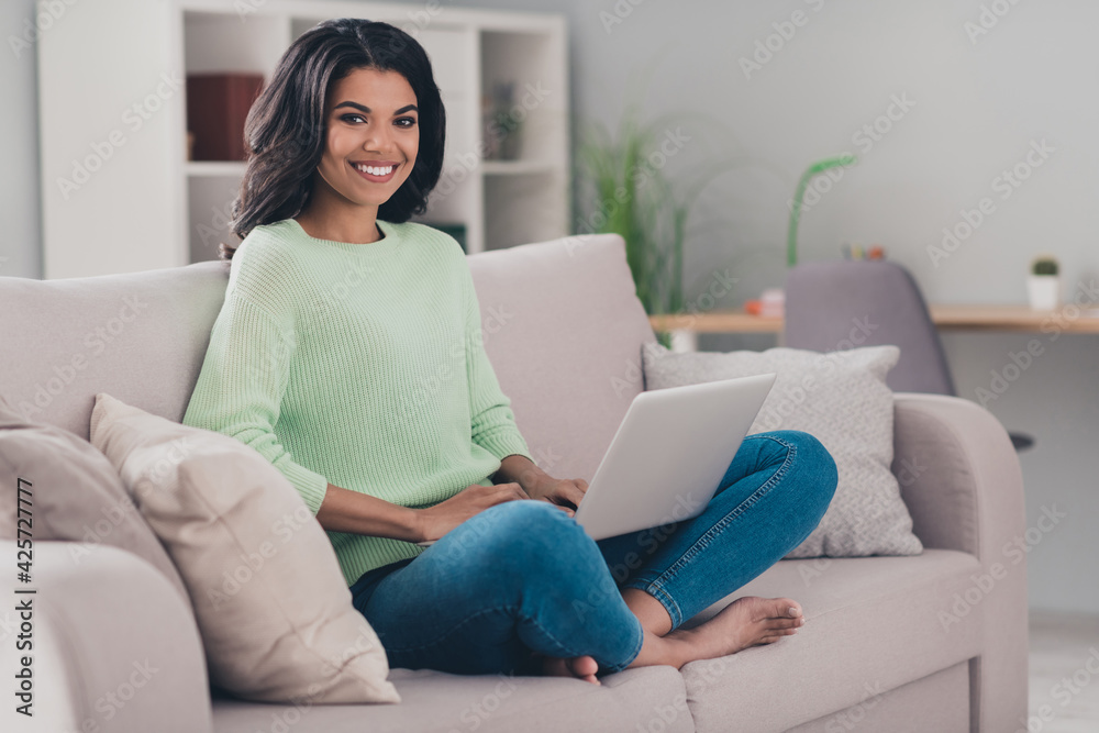 Sticker Full body photo of young attractive afro woman happy positive smile sit couch browse laptop chat type email indoors