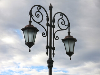 Fototapeta na wymiar beautiful forged vintage lantern on a gray sky background