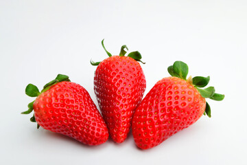 Three strawberries close up on white background. Strawberry isolated. Strawberries with leaf isolate. Whole strawberry on white. Strawberries isolate. Top view strawberries set. Full depth of field.