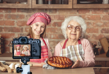 Granddaughter and her granny with fruit pie