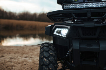 headlights in the background a river and sand. sport and extreme concept © руслан малыш