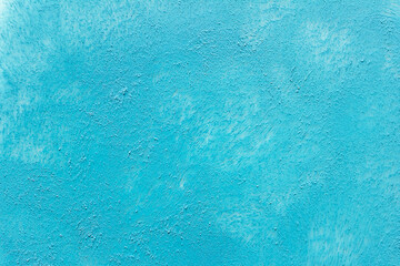Textured blue acrylic paint background with marks left by sponge. 