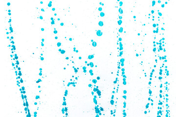 Abstract dots blue acrylic ink color splashes ink blots on white background.