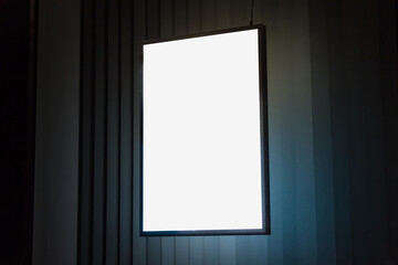 A4 vertical glowing light box mockup template at night.