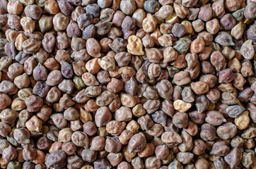 Top view of dry organic brown chickpea bean seeds background in dark tone