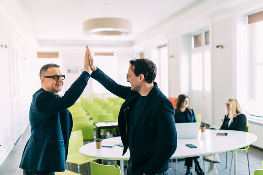 Businessman Giving High Five To His Partner On Meeting, Positive Management Team Celebrating Victory, Successful Stock Deal, Sales Growth, Won Good Contract, Business Achievement And Teamwork Concept