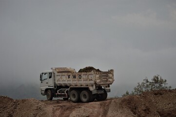 Fototapeta premium ISLAMABAD, PAKISTAN - JANUARY 27,2016: different view of truck standing of sand terrain for background, selective focus