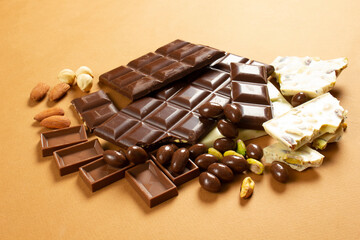 White and milk chocolates. Almond, pistachio, hazelnut.. background, texture..