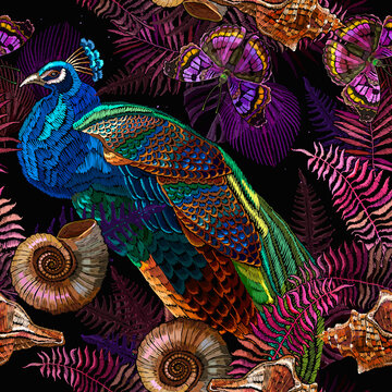 Colorful peacocks birds, ammonite fossil, butterfllies and palm leaves. Seamless pattern. Embroidery. Tropical forest background. Paradise garden art. Template for clothes