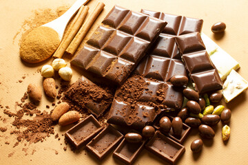 White and milk chocolates. Almond, pistachio, hazelnut.. background, texture..