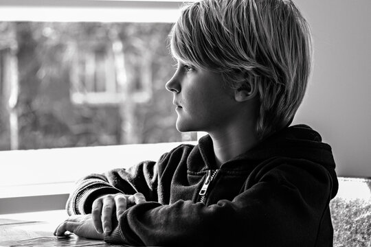 boy staring at the window