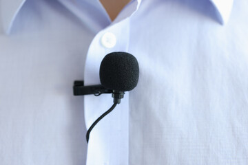 Lapel microphone is worn on men blue shirt